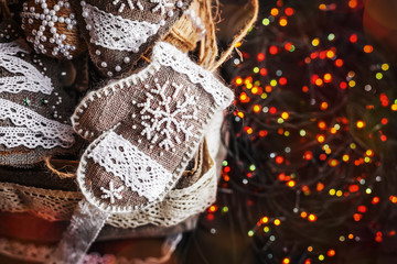 Christmas sackcloth gifts in box. background xmas garland and decorations with toys, sparking, glowing. Happy New Year and Xmas theme. handmade decor