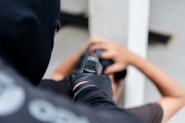 The criminals use guns pointed head hostage,selective focus