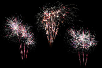 Festive fireworks colorful display isolated in bursting shapes on black background. Beautiful light for celebration. Show explosion happy new year wallpaper.