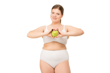 overweight woman in underwear holding apple