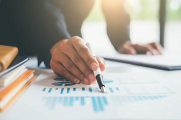 Business concept. Business people discussing the charts and graphs showing the results of their successful teamwork.