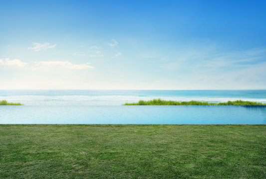 Empty grass floor deck in luxury beach house with blue sky background, Sea view terrace at vacation home or hotel, Photo and 3d rendering of swimming pool combined
