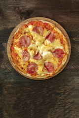 Cut pepperoni pizza with place for text, overhead shot