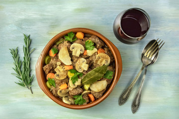 Overhead photo of meat and mushrooms ragout with wine