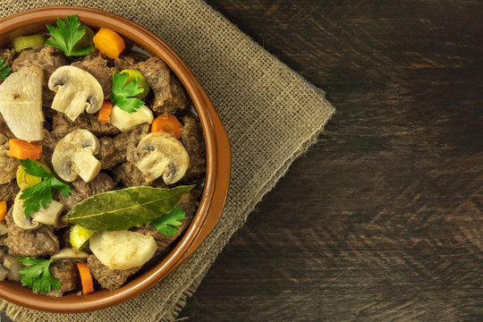 Overhead photo of meat and mushrooms ragout with copyspace
