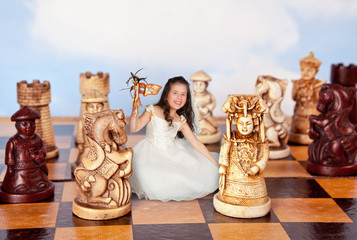 Mini girl on chessboard