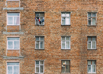 Brick wall with windows of an old apartment house seamless background