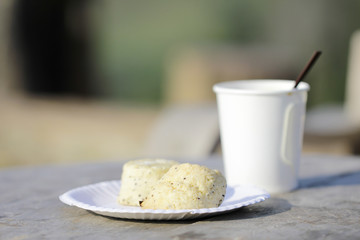 Two white wholemeal biscuits with a white cup