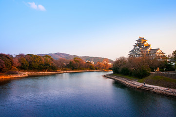 Fototapeta na wymiar Okayama Castle and river in early autumn.