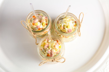 Russian salad in the glass can