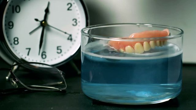 Dentures Fall on Cleaning Solution Super Slow Motion