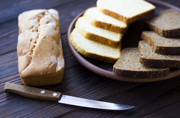 Cupcake and bread on a clay platter on the table. Healthy fresh food.