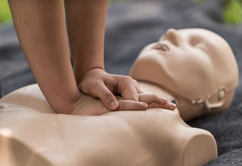 Cpr training outdoors. Reanimation procedure on CPR doll