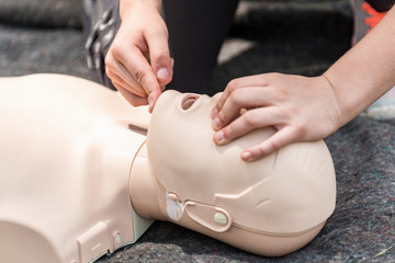 Cpr training outdoors. Reanimation procedure on CPR doll