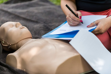 Cpr training outdoors. Reanimation procedure on CPR doll