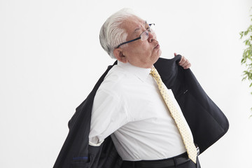 Old man with shoulder pain hard to wear suits