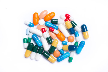 colored pills and capsule on white background