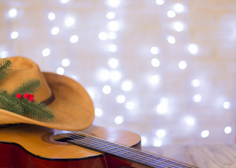 Country music christmas with acoustic guitar and american cowboy hat