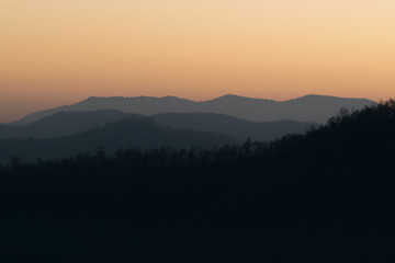 Morning sunrise with mountains in front.