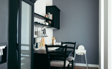 Modern kitchen with black table and chairs