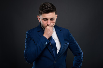 Businessman in formalwear sitting in pensive mood