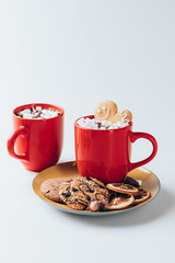cookies and cups of hot cacao