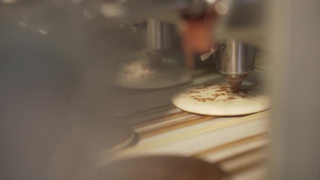 The cookie moves along the conveyor. Cookies on the conveyor