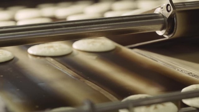 The cookie moves along the conveyor. Cookies on the conveyor