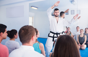 Obraz na płótnie Canvas Karate coach teaching adults
