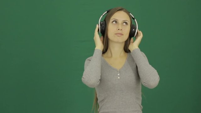 Young cute girl listens music, chromakey  