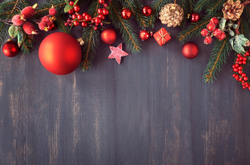 Christmas background with fir twigs, berries and Christmas baubles
