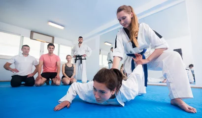 Photo sur Plexiglas Arts martiaux Female coach showing painful hold