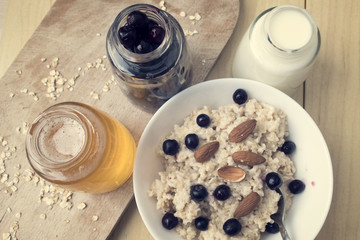 Delicious oatmeal porridge with berry and almonds for breakfast.