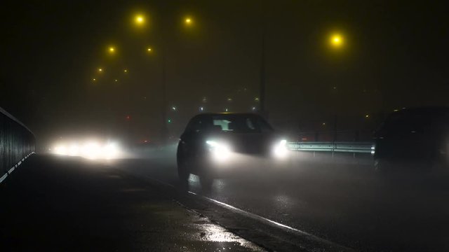 A traffic at fogy evening in winter in Prague.Night City Traffic In The Fog