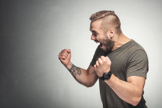 Excited man in a victorious gesture.