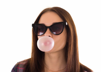 Young cute girl chews bubble gum, isolated  