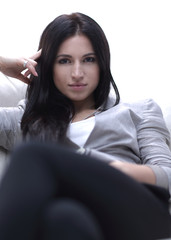 Close-up portrait of a beautiful young woman sitting in a chair