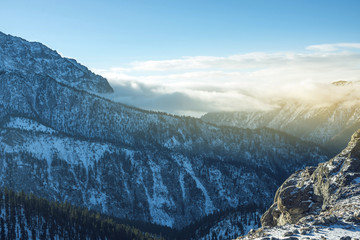 Beautiful view of the mountain peaks of the Baikal mountains in the snow at sunrise. Concept of travel and Hiking trips