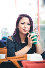 Beautiful girl drinking coffee at the coffee shop