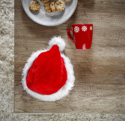Obraz na płótnie Canvas Photo of carpet above the floor. Free space for your decoration. Red santa claus hat.