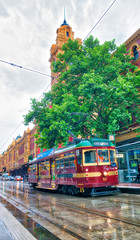 MELBOURNE - NOVEMBER 2015: City tram along the streets on a rainy day. Trams are a tourist...