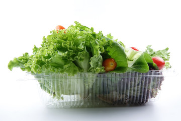Closeup of a pile of lettuce mix for salad on a white background