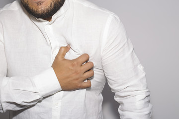 Man having a pain in the heart on white