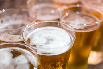 glasses of light beer on a dark pub