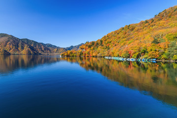 Fototapeta na wymiar View of Chuzenji lake in autumn season with reflection water in Nikko, Japan