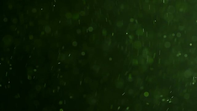 Green Dust Particles Fly Against A Dark Background