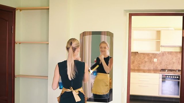 Merry maid cleans a mirror