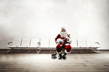 Old red santa claus siting on chairs. White wall background for your text ora wooden floor for your product. 