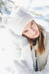 Girl in hat and mittens smiling in the winter