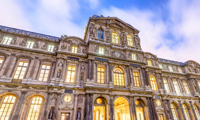 Fototapeta premium Exterior of Louvre buildings at night